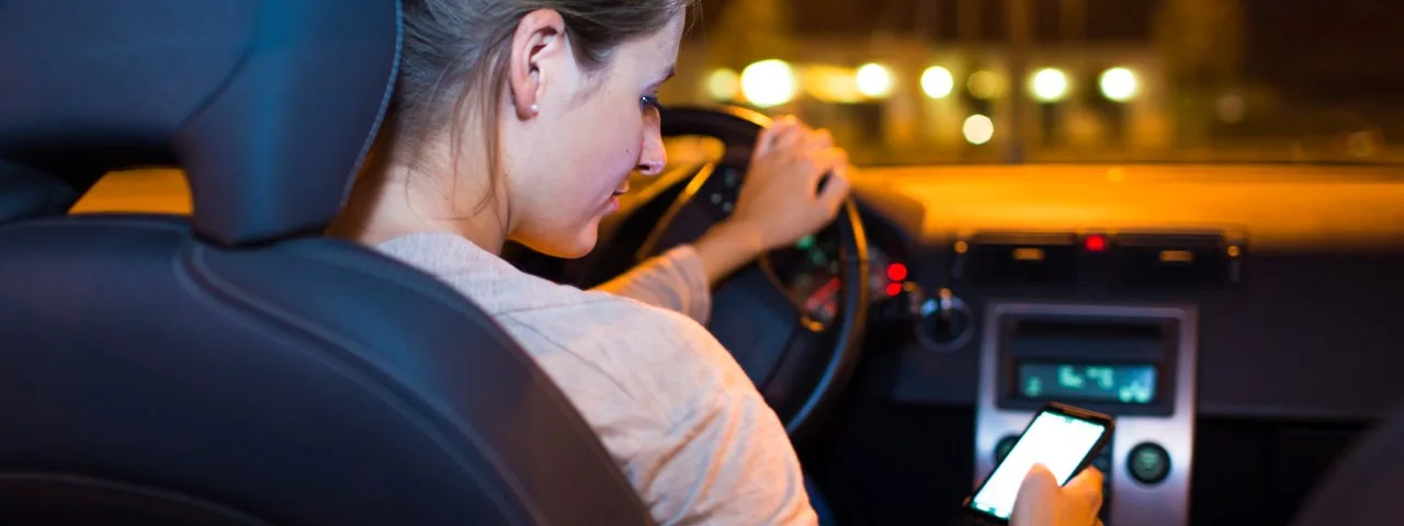 Unsafe phone use while driving at night — a mistake to avoid